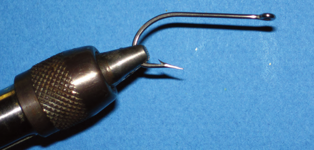 1. Set the hook, point down, in the vise and sharpen as necessary.