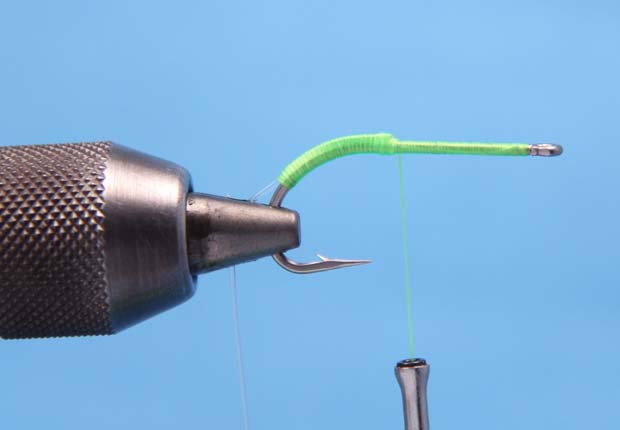 1. Start the thread at the eye of the hook and lay down a layer of thread until you reach the point of the hook. Tie in a 3 inch piece of monofilament on top of the hook shank. Cover the monofilament with a layer of thread until you reach the middle of the bend. Wrap back to the point of the hook. 