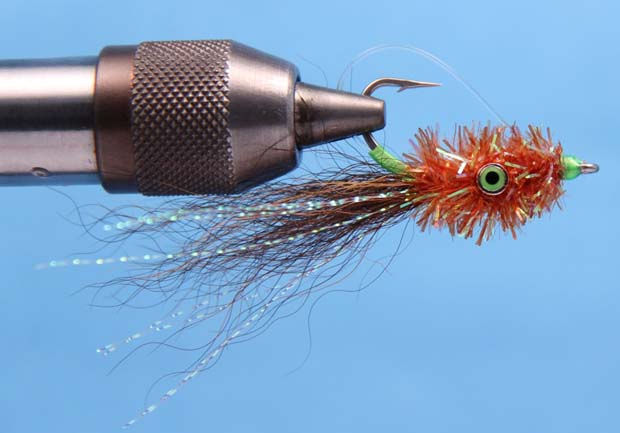 7. Once you have secured the monofilament and Crystal Chenille with several tight wraps, cut away the excess. Pull back the fibers and build a thread head behind the eye of the hook. Whip-finish, cut away the thread and apply a thin coat of head cement or Clear Cure Goo Hydro to complete the fly. 