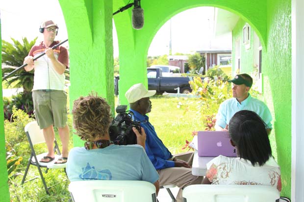 Tom Karrow (seated to right) interviewing and filming legendary guide, David Pinder Sr. on Grand Bahama island in downtown McLean's Town. Filming credit, Fisheries Conservation Foundation. 