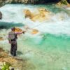 A fly fisherman fishing in a river