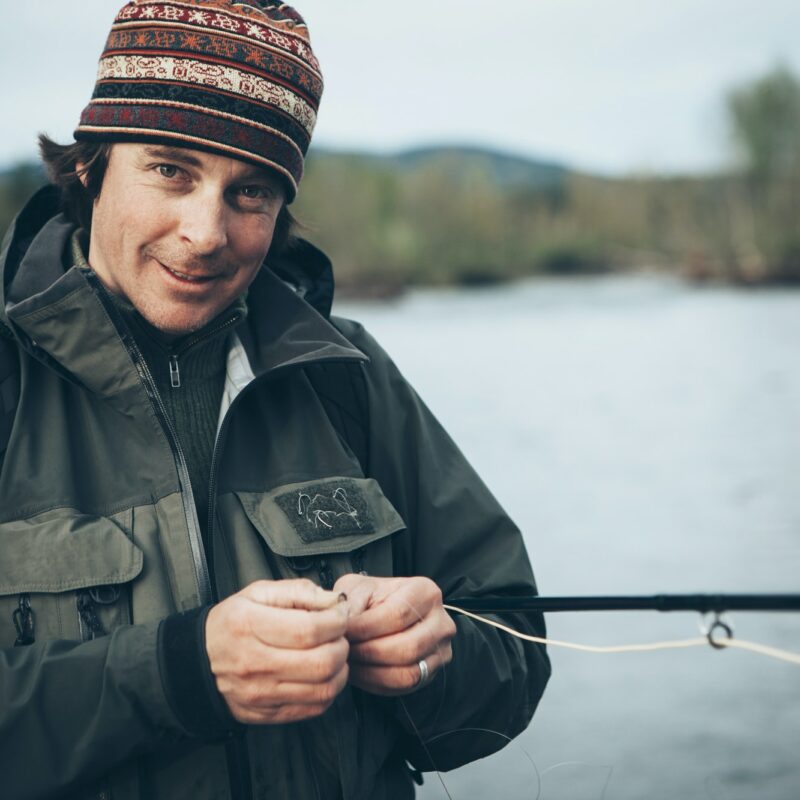 Middle aged man fly fishing on the Hoh River, Olympic National Park, Washington.
