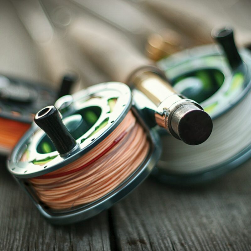 Fly fishing rod and reel on a wooden surface