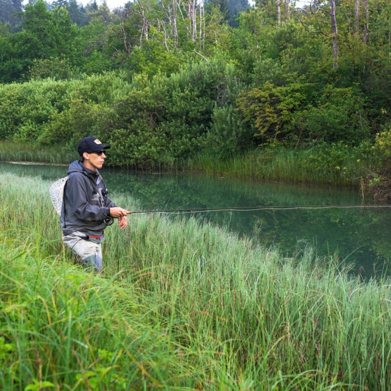 A fly fisherman fishing in a river