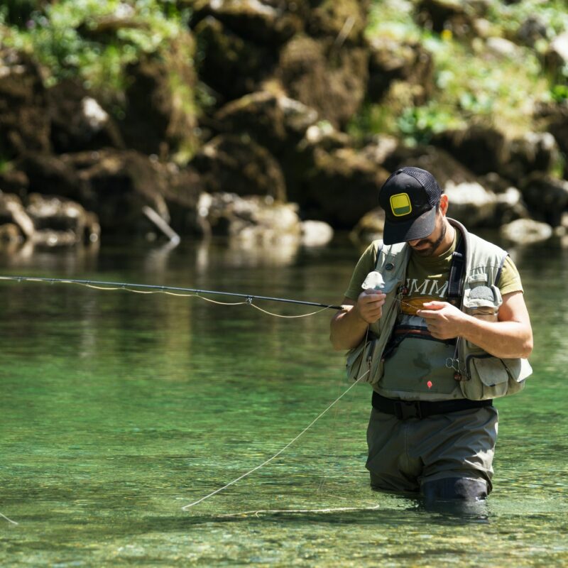 Fly fisherman flyfishing in river
