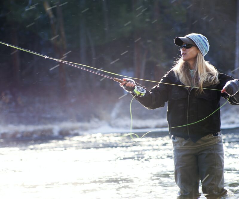 Determined Woman Fishing In Lake On Sunny Day