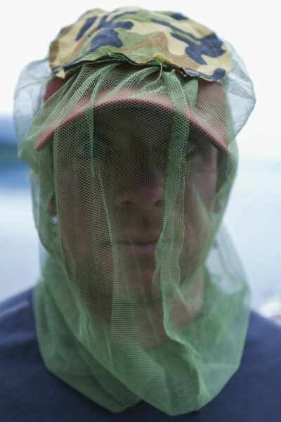 Close up of man wearing protective mosquito netting